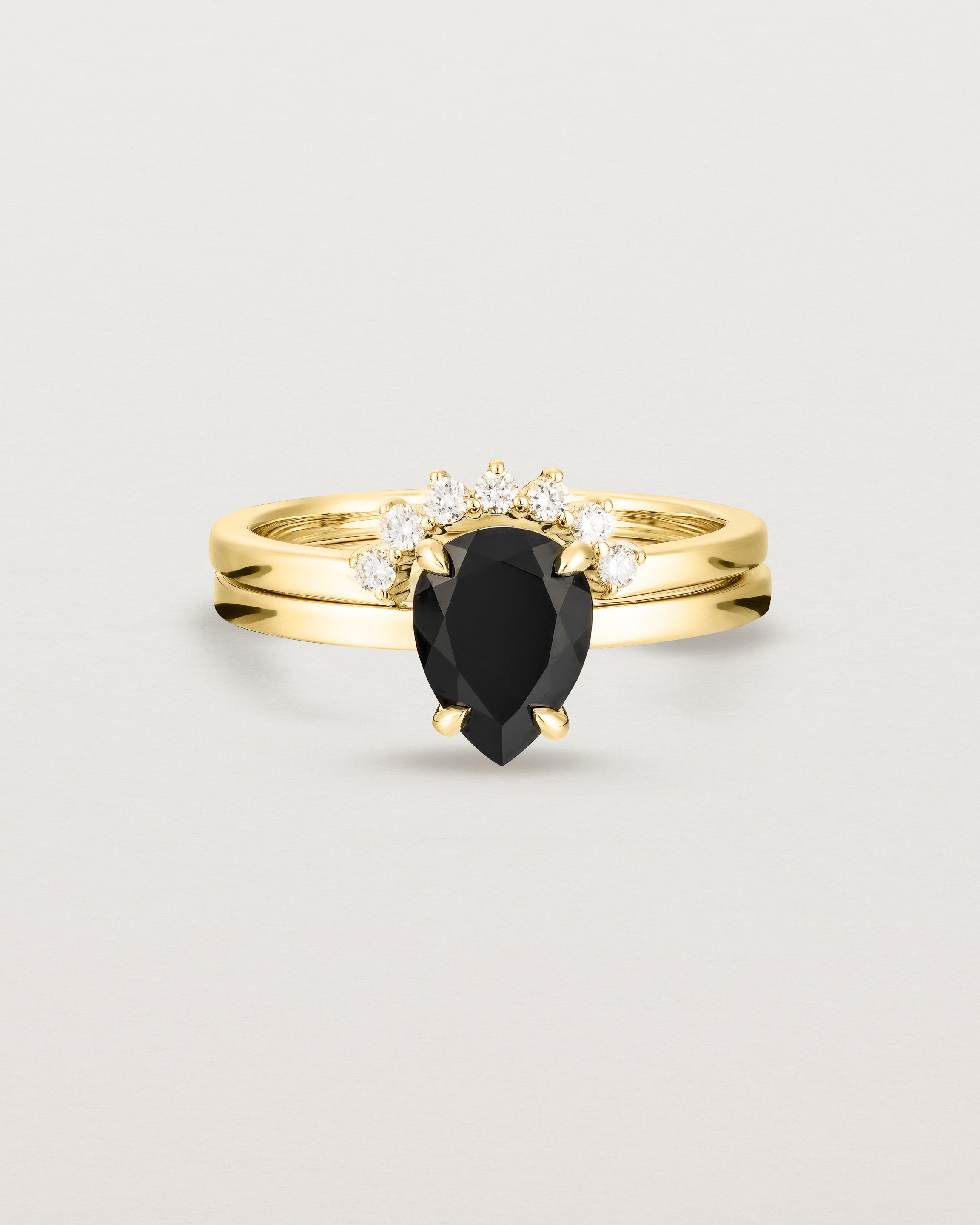 Front view of the Una Pear Solitaire | Black Spinel | Yellow Gold stacked with the Reina Crown Ring | Diamonds.