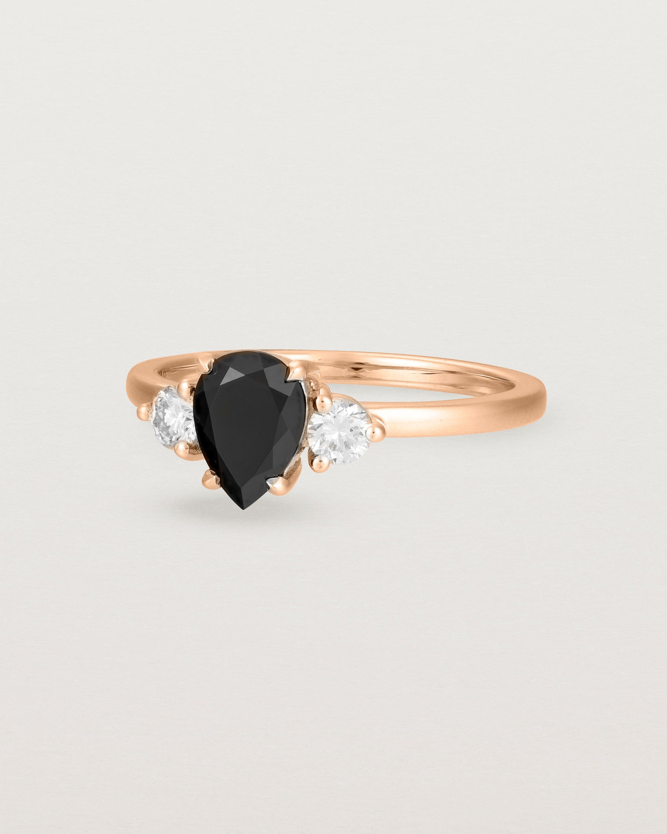 Angled view of the Una Pear Trio Ring | Black Spinel & Diamonds | Rose Gold