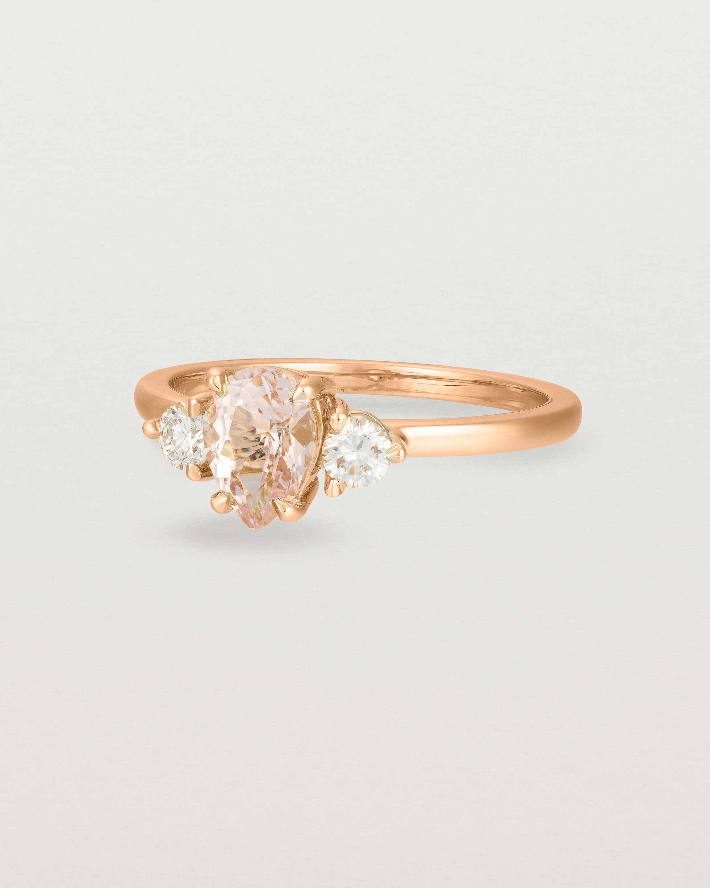Angled view of the Una Pear Trio Ring | Morganite & Diamonds | Rose Gold.