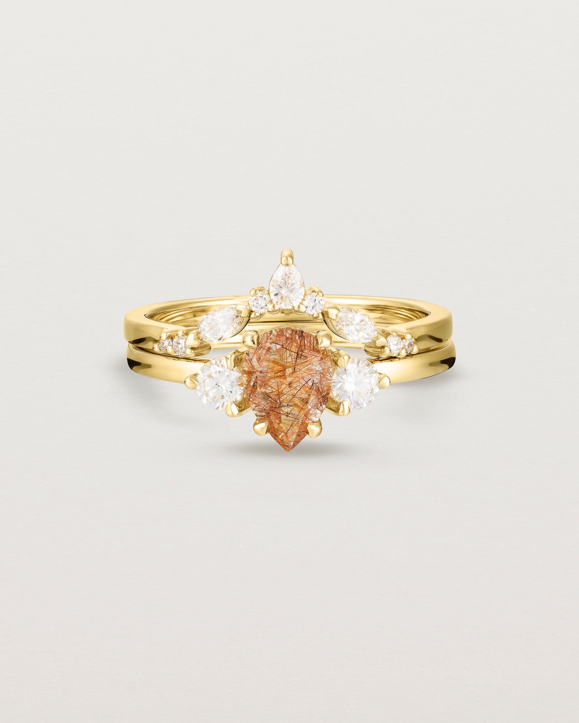 Front view of the Una Pear Trio Ring | Rutilated Quartz & Diamonds | Yellow Gold stacked with the Meia Crown Ring. 