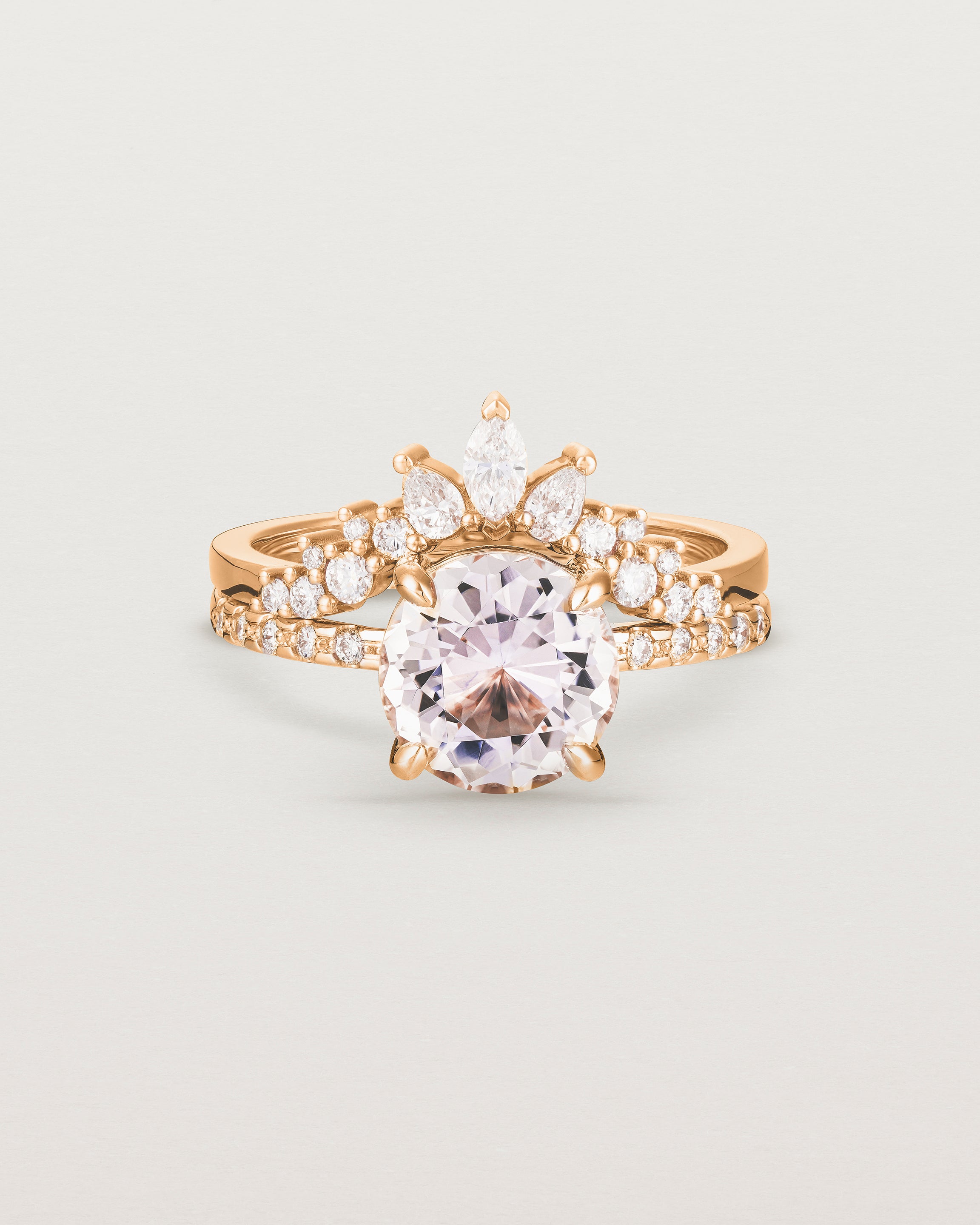 Front view of the Una Round Solitaire | Morganite | Rose Gold with cascade Diamond Shoulders, stacked with the Thalia Crown Ring.