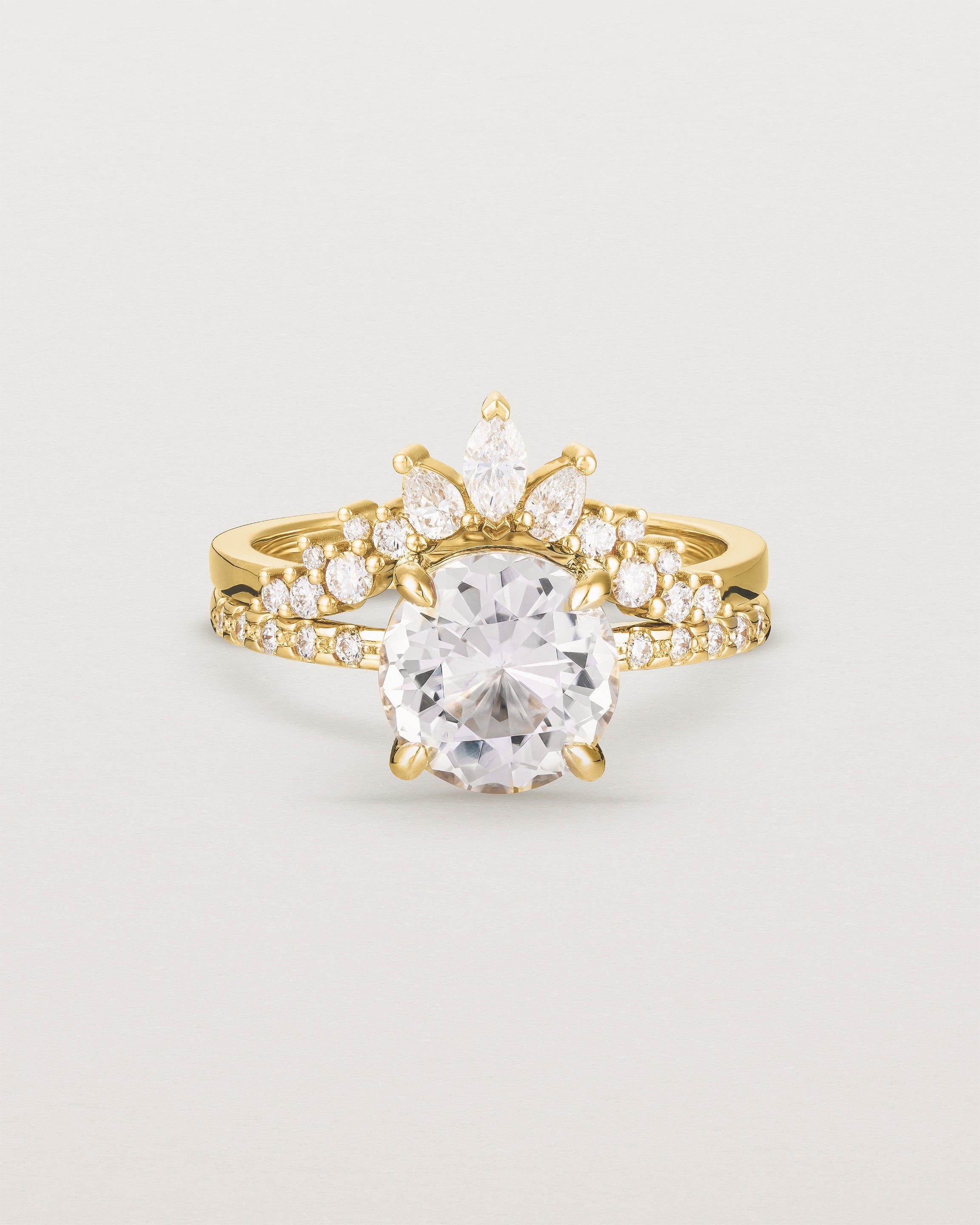 Front view of the Una Round Solitaire | Morganite | Yellow Gold with cascade Diamond shoulders stacked with the Thalia Crown Ring. 