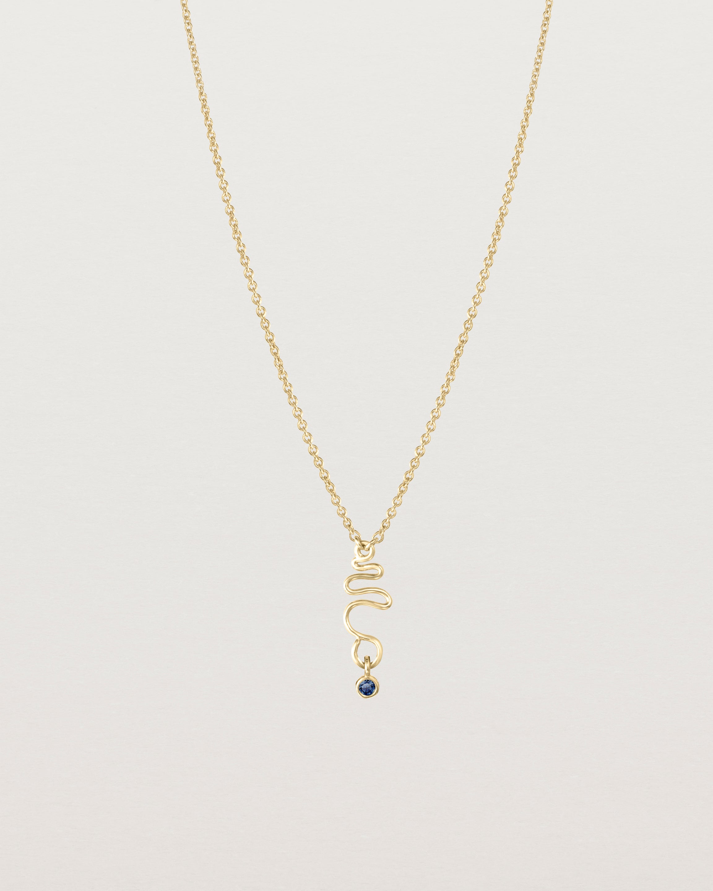 Front on deep etched image of a yellow gold necklace with birthstone charms.