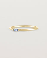 Angled view of the Vega Stacking Ring | Sapphire in yellow gold.