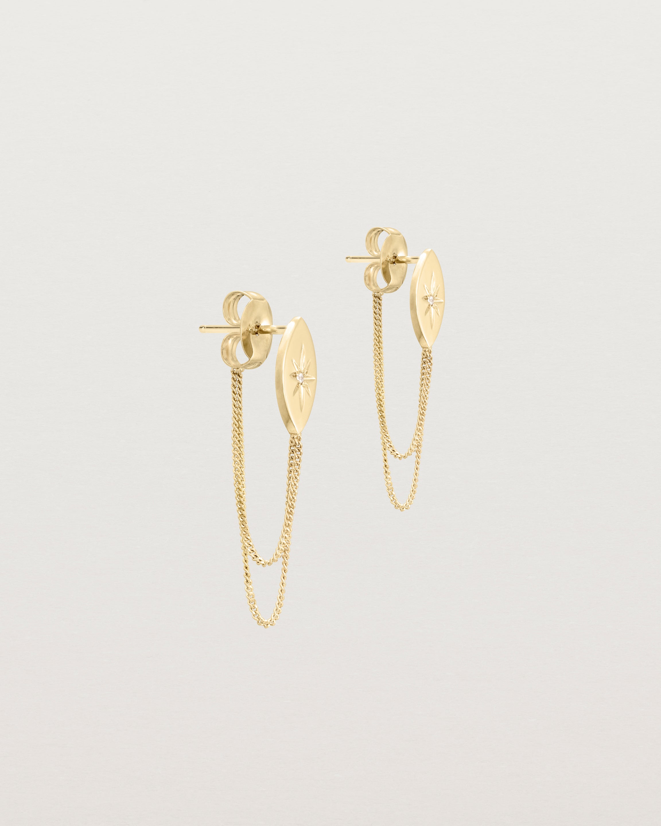 Angled view of the Willow Loop Studs | Birthstone in yellow gold with white diamonds.