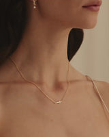 video of model wearing the ember charm necklace with white diamond
