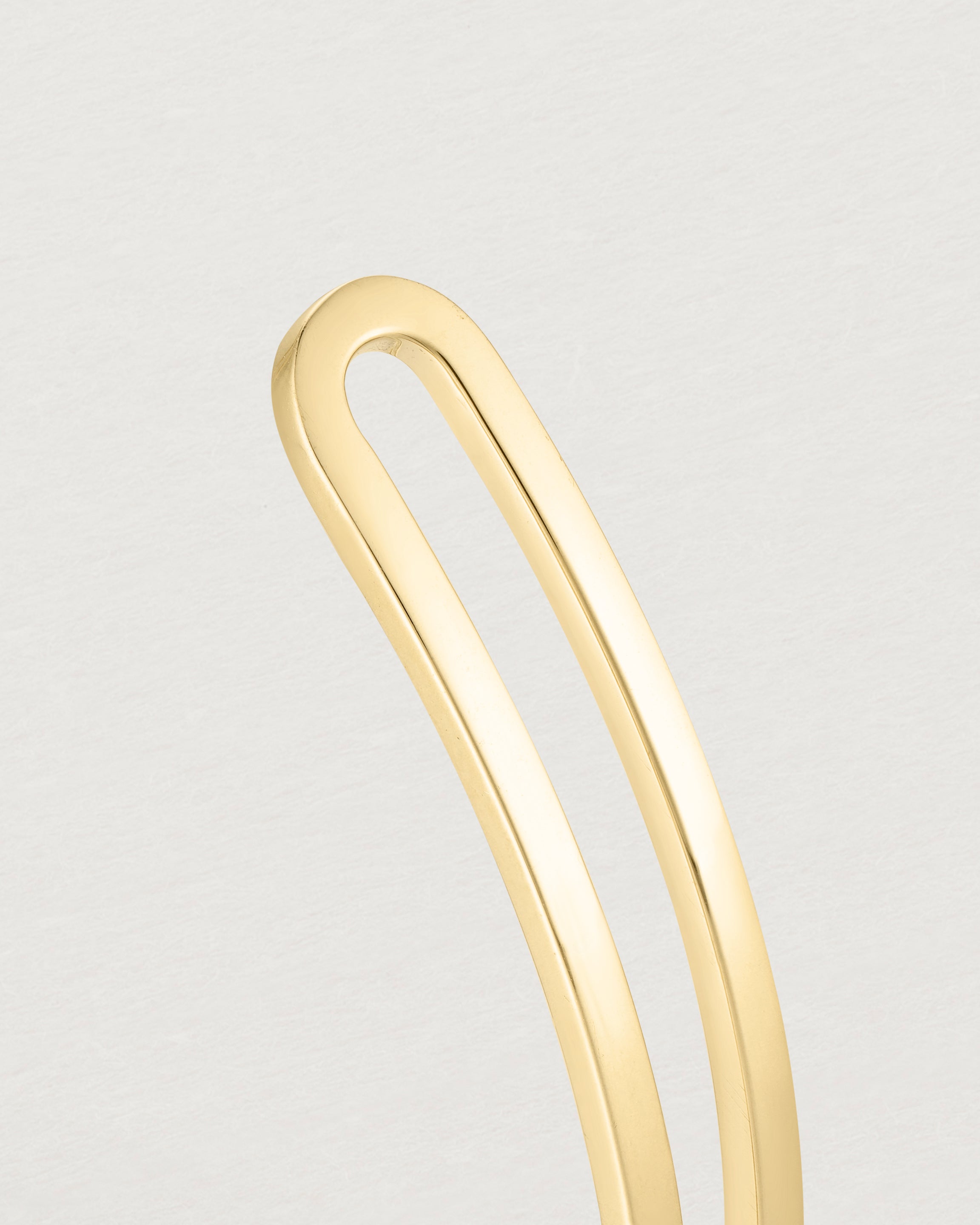 Close up of the detail of the Ailing Cuff Bangle in Yellow Gold.