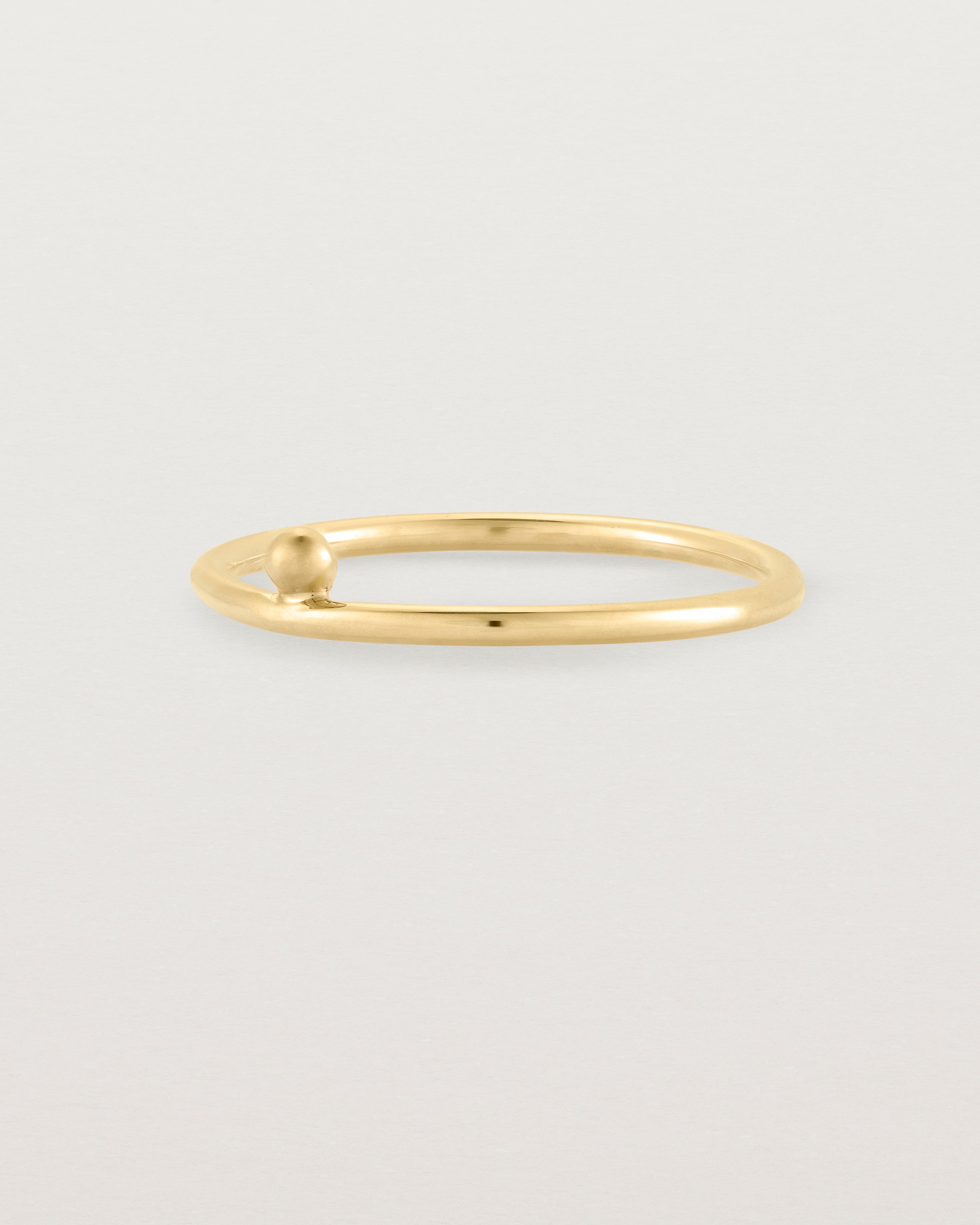 yellow gold fine ring with a single dot detail