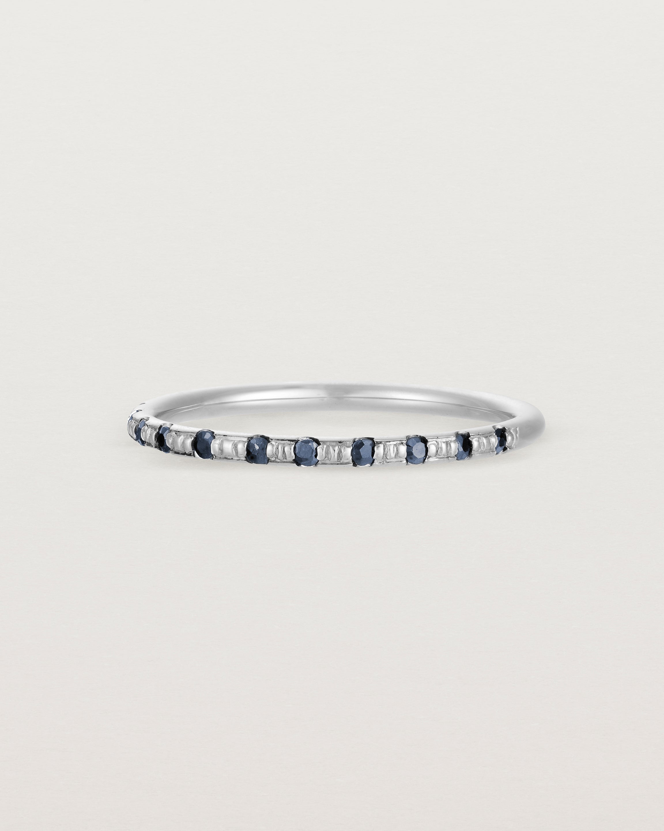 Angled View of Cascade Round Profile Wedding Ring | Sapphire | White Gold 