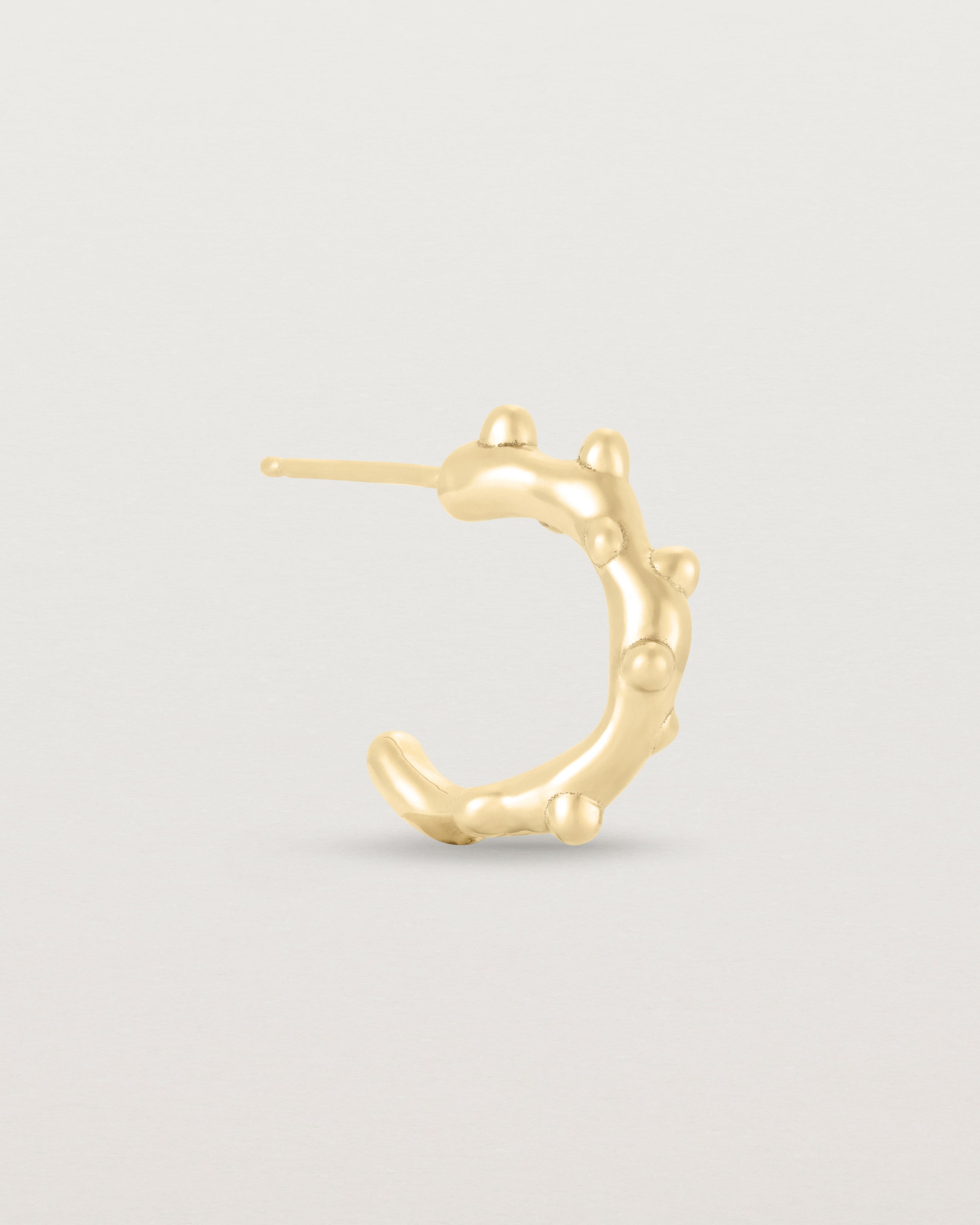 A side view of the Dotted Organic Hoops | Yellow Gold.