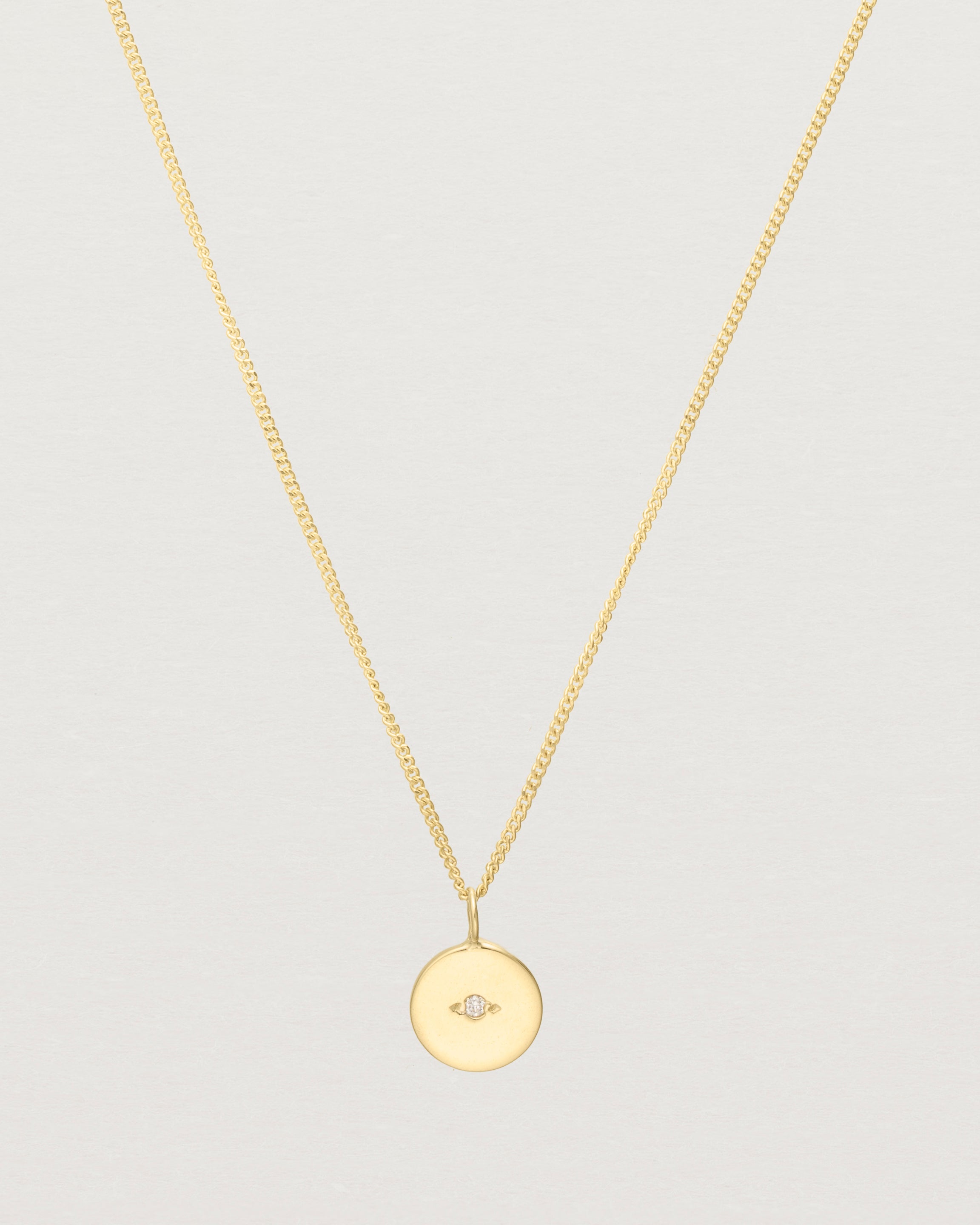Close up view of the Eily Necklace with a diamond in yellow gold.