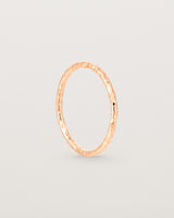 Standing view of the Faceted Wedding Ring in Rose Gold.