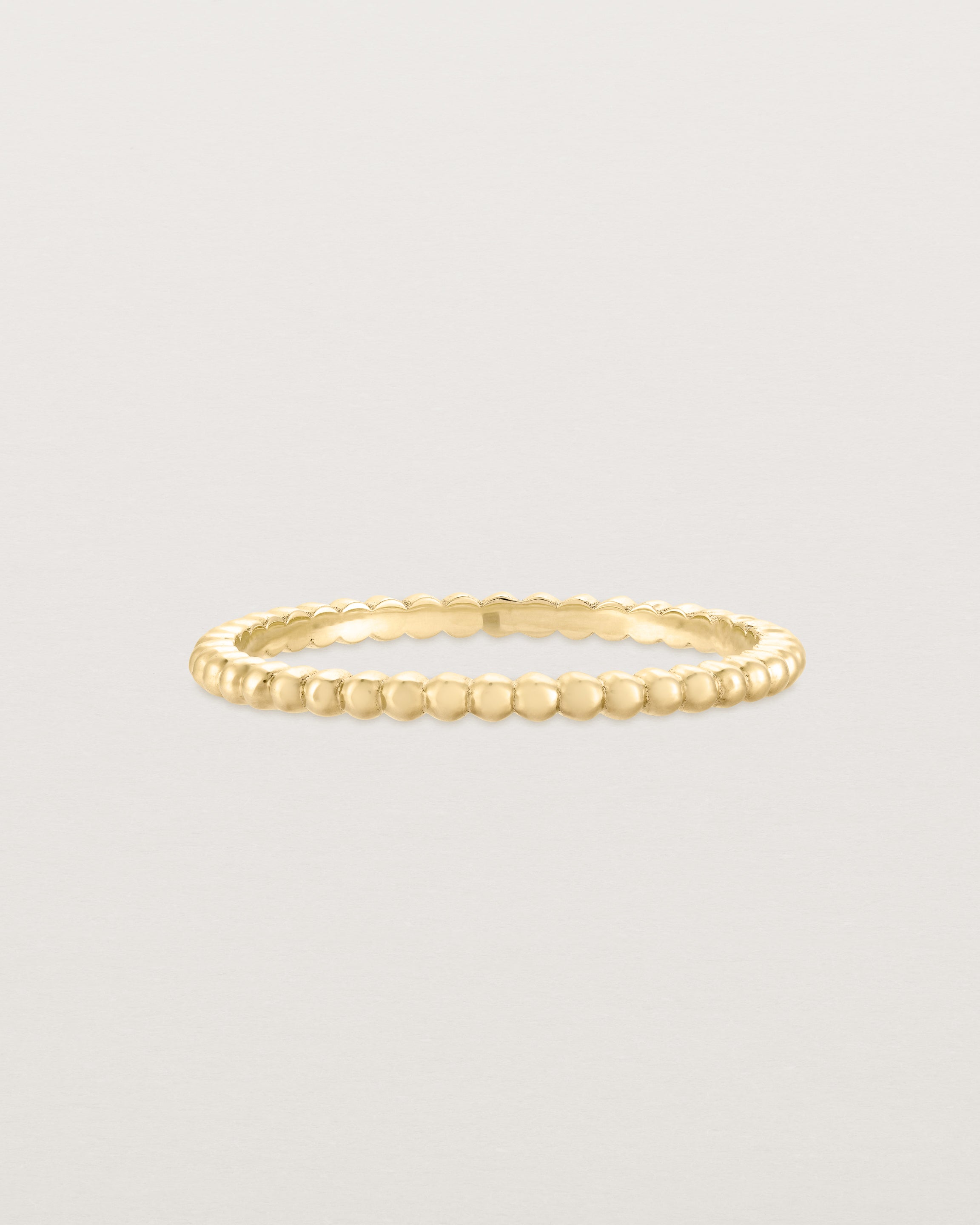 Front view of the Dotted Stacking Ring in Yellow Gold.