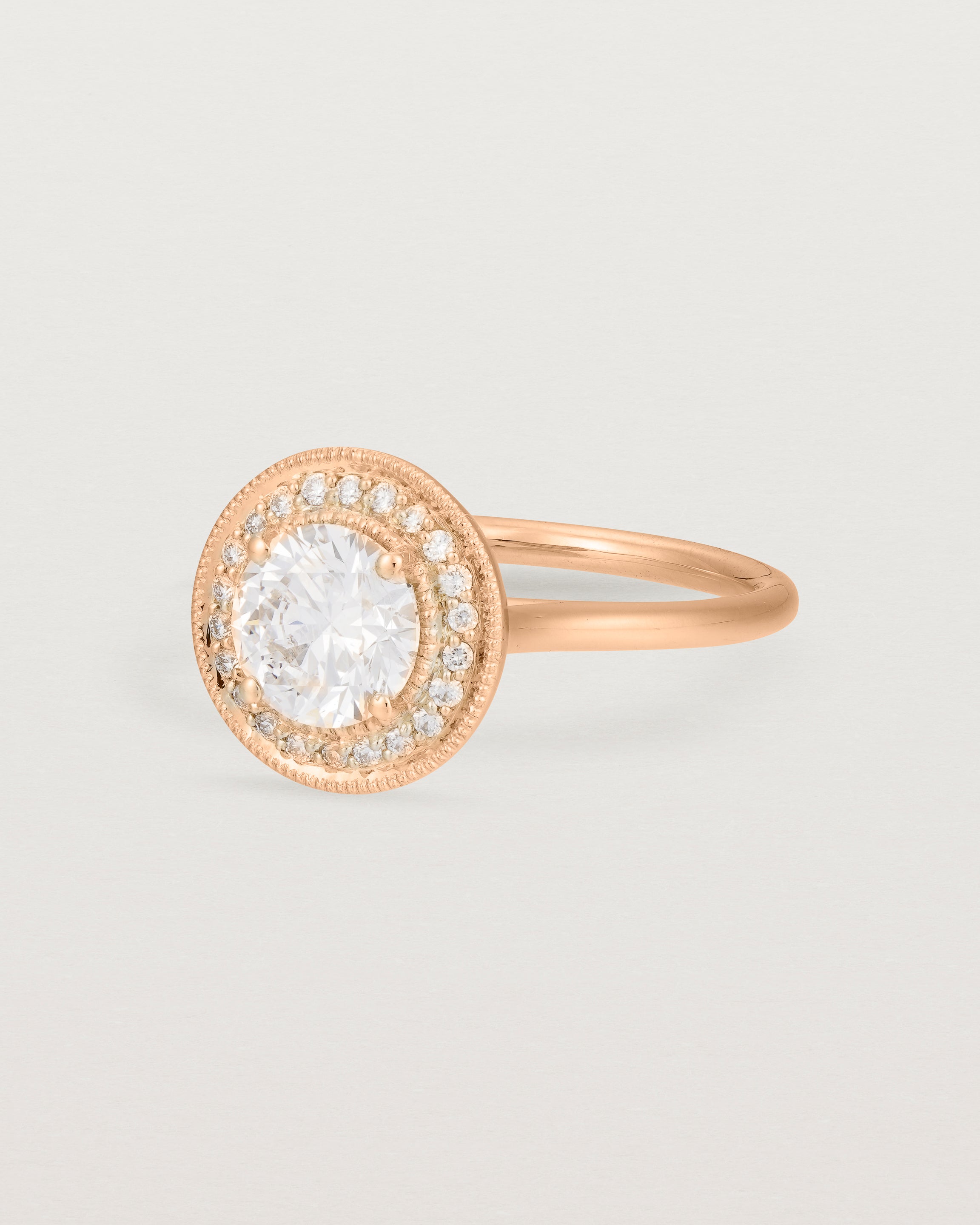 Angled view of the Imogen Halo Ring | Laboratory Grown Diamonds in Rose Gold.