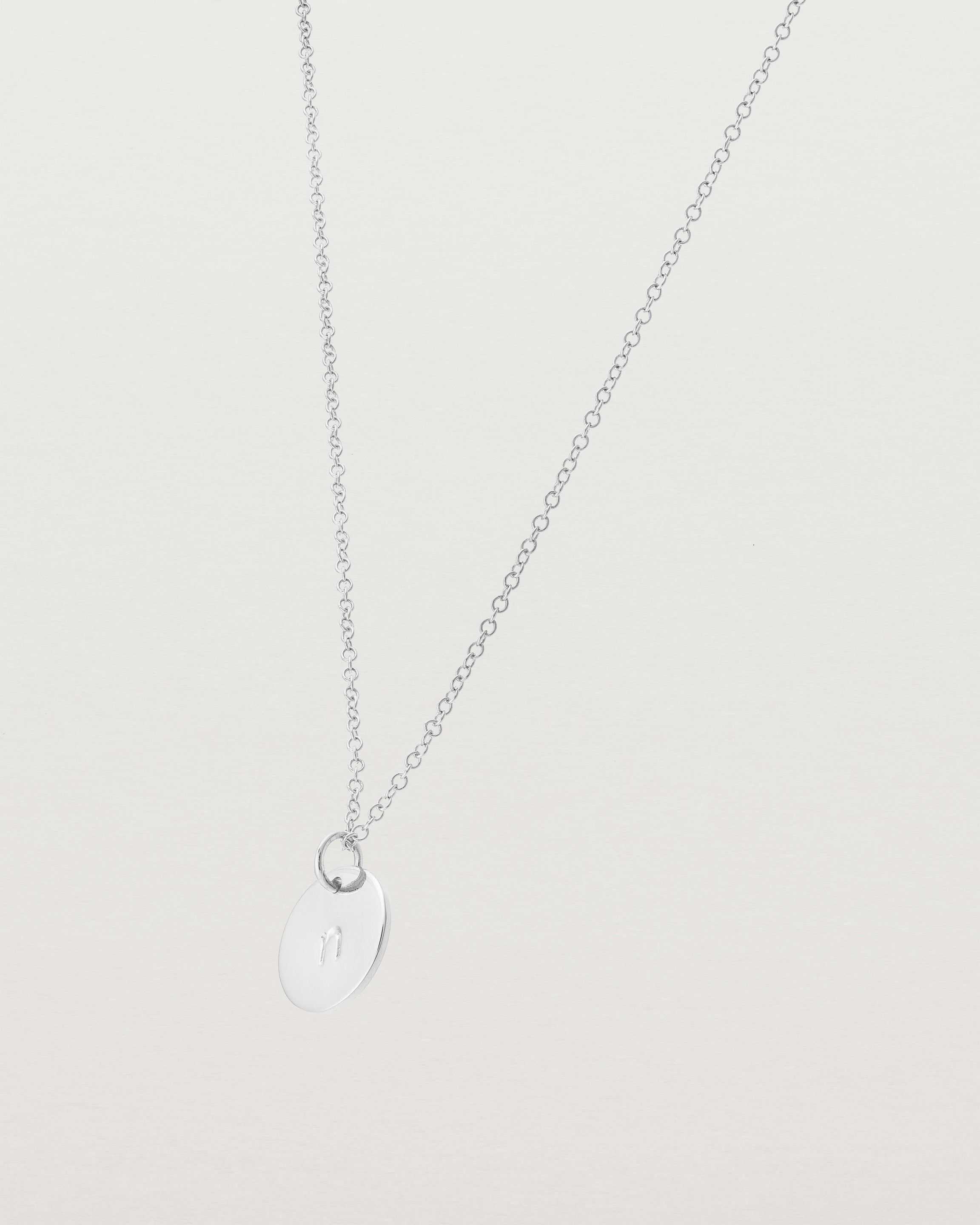 Angled view of the Mini Initial Necklace in Sterling Silver.