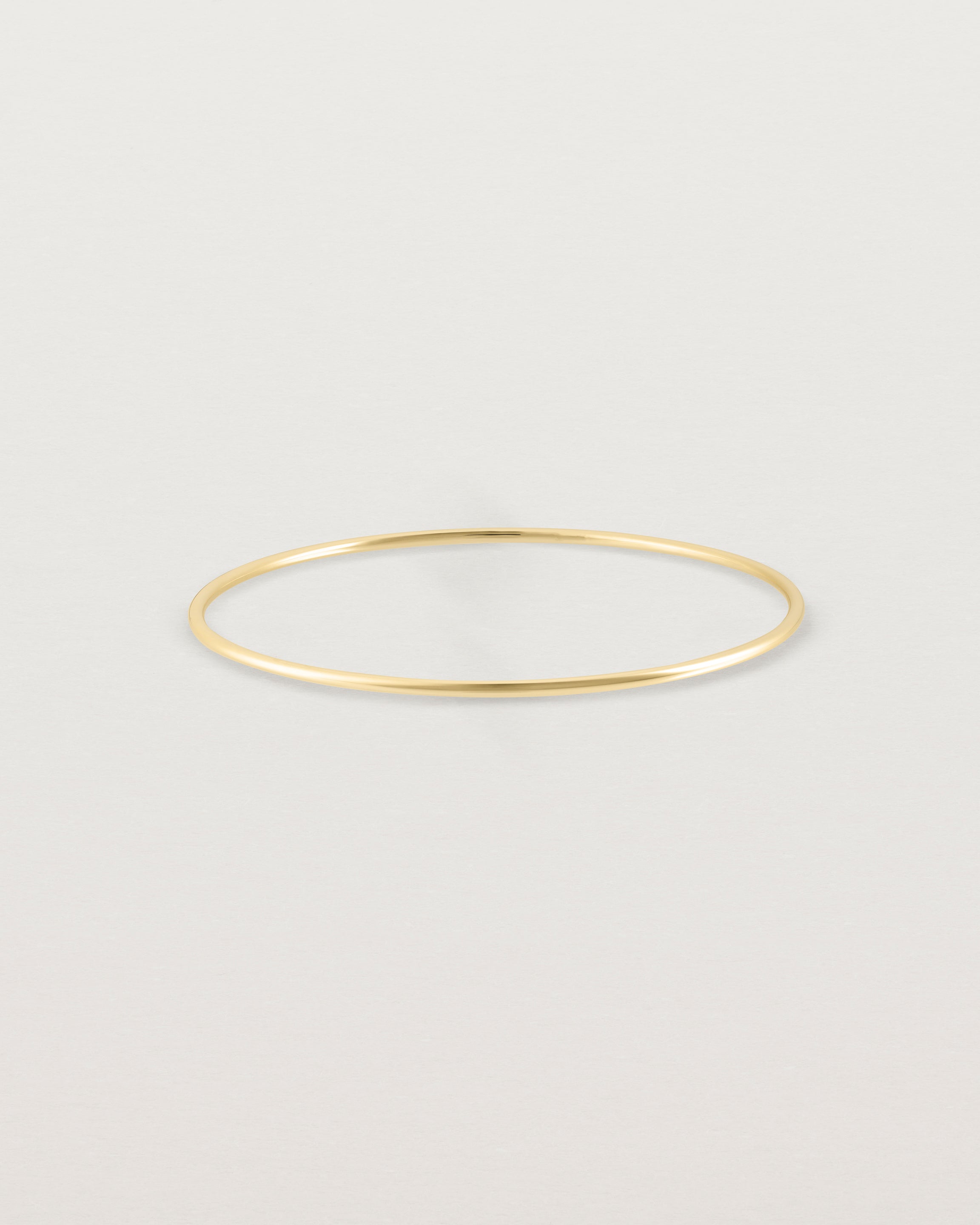 Front view of the Oval Bangle in Yellow Gold.