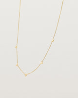 Angled view of the Tellue Necklace in yellow gold.