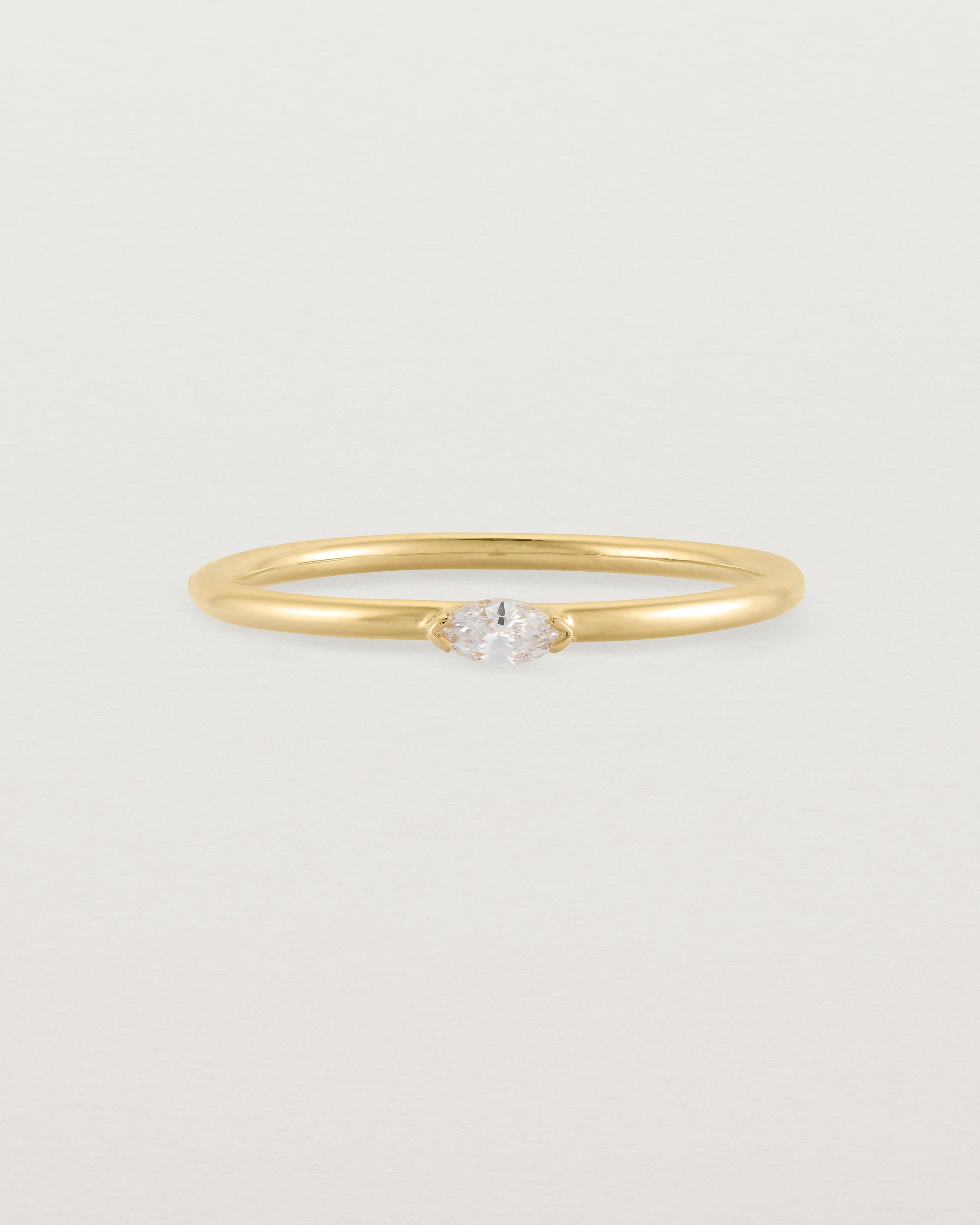 Fine yellow gold stacking ring featuring a white marquise centre diamond