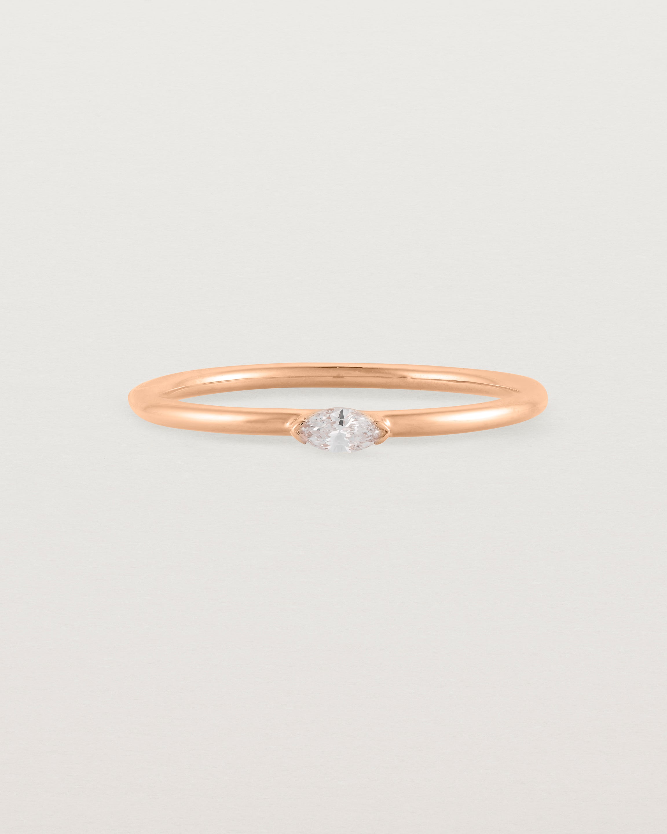 Fine rose gold stacking ring featuring a white marquise centre diamond