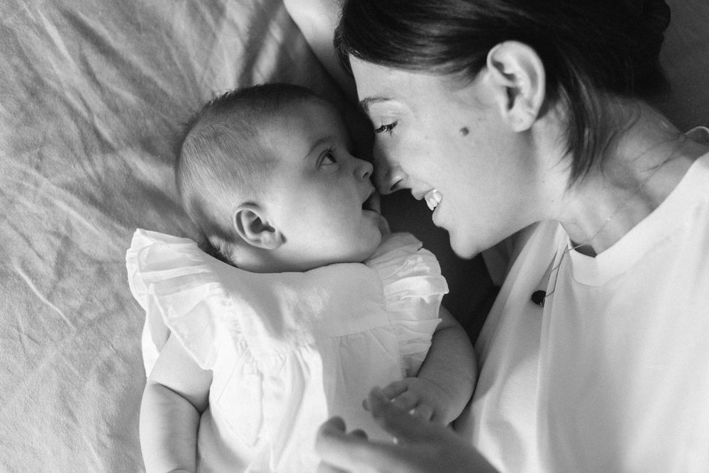 Amanda Bardas lying next to her baby daughter