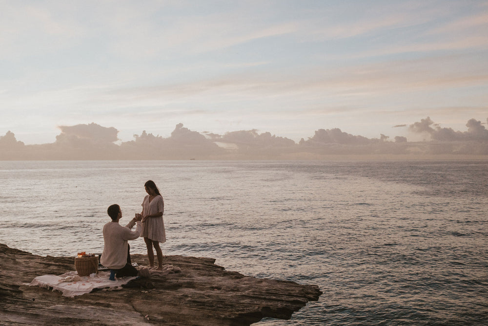 Calvin proposing to Eunica on the headland in Sydney over seeing the ocean