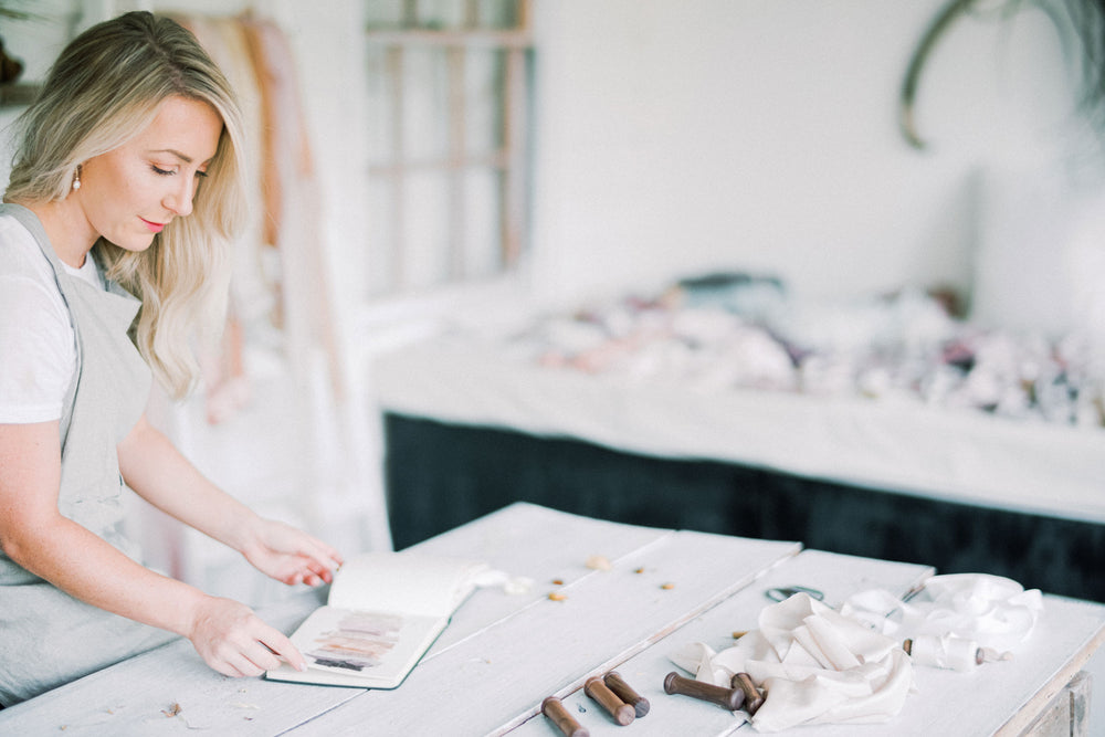 Lauren founder of Silk and Bramble at her work station to create silk ribbons 