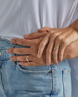 A female wears the 2mm organic wedding ring and male model wears the 6mm organic wedding ring, in yellow gold