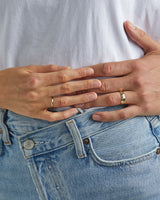 A female wears the 2mm knife edge wedding ring and male model wears the 6mm knife edge wedding ring, in yellow gold
