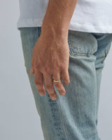 A model wears our 3mm classic wedding ring in yellow gold