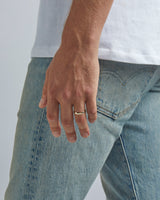 A model wears our 4mm classic wedding ring in yellow gold