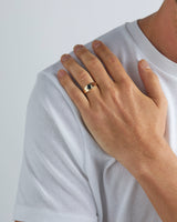 Male wearing the Amos Signet Ring which features an Australian Sapphire in Yellow Gold. 