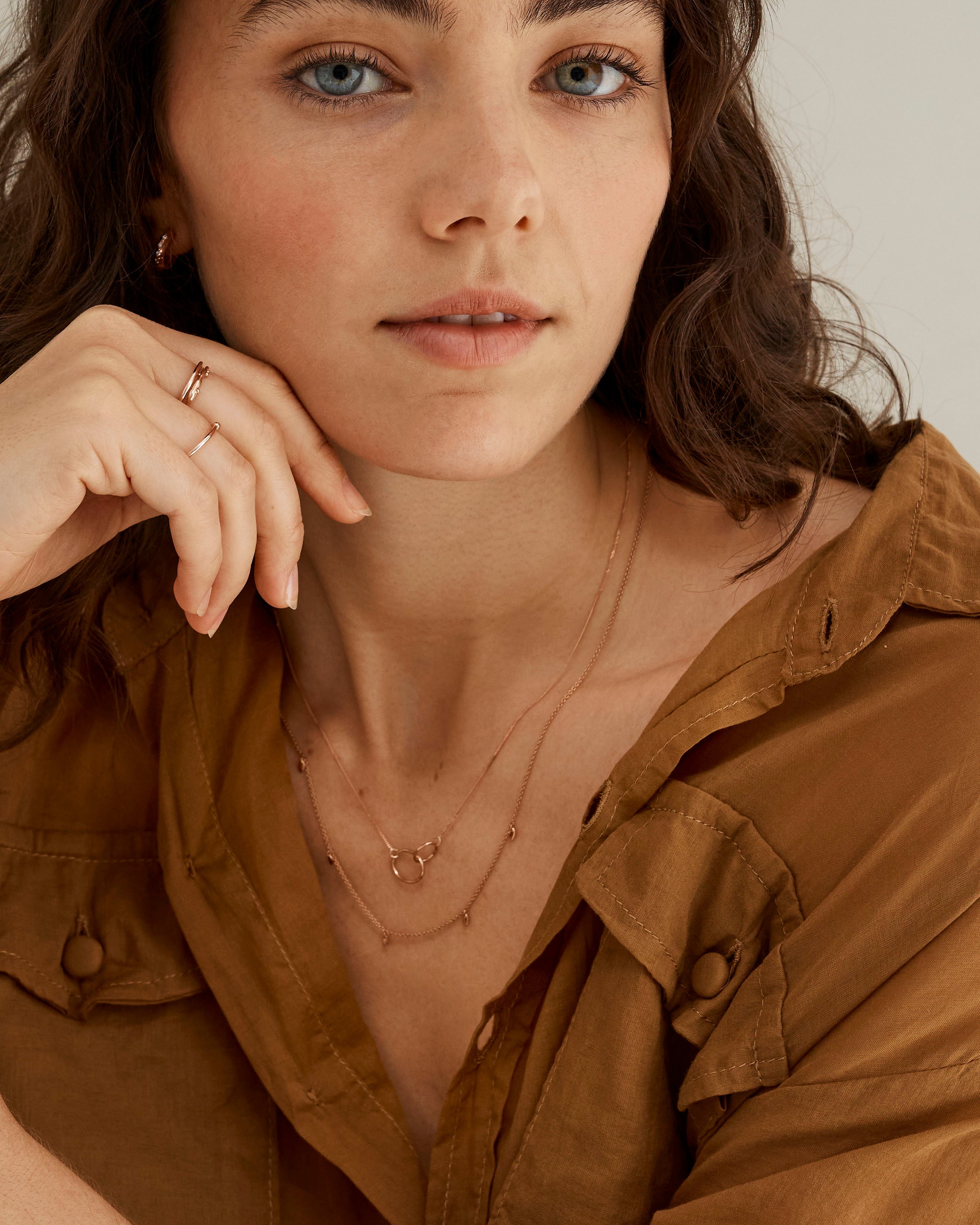 A woman wearing the Loop Through Oval Necklace