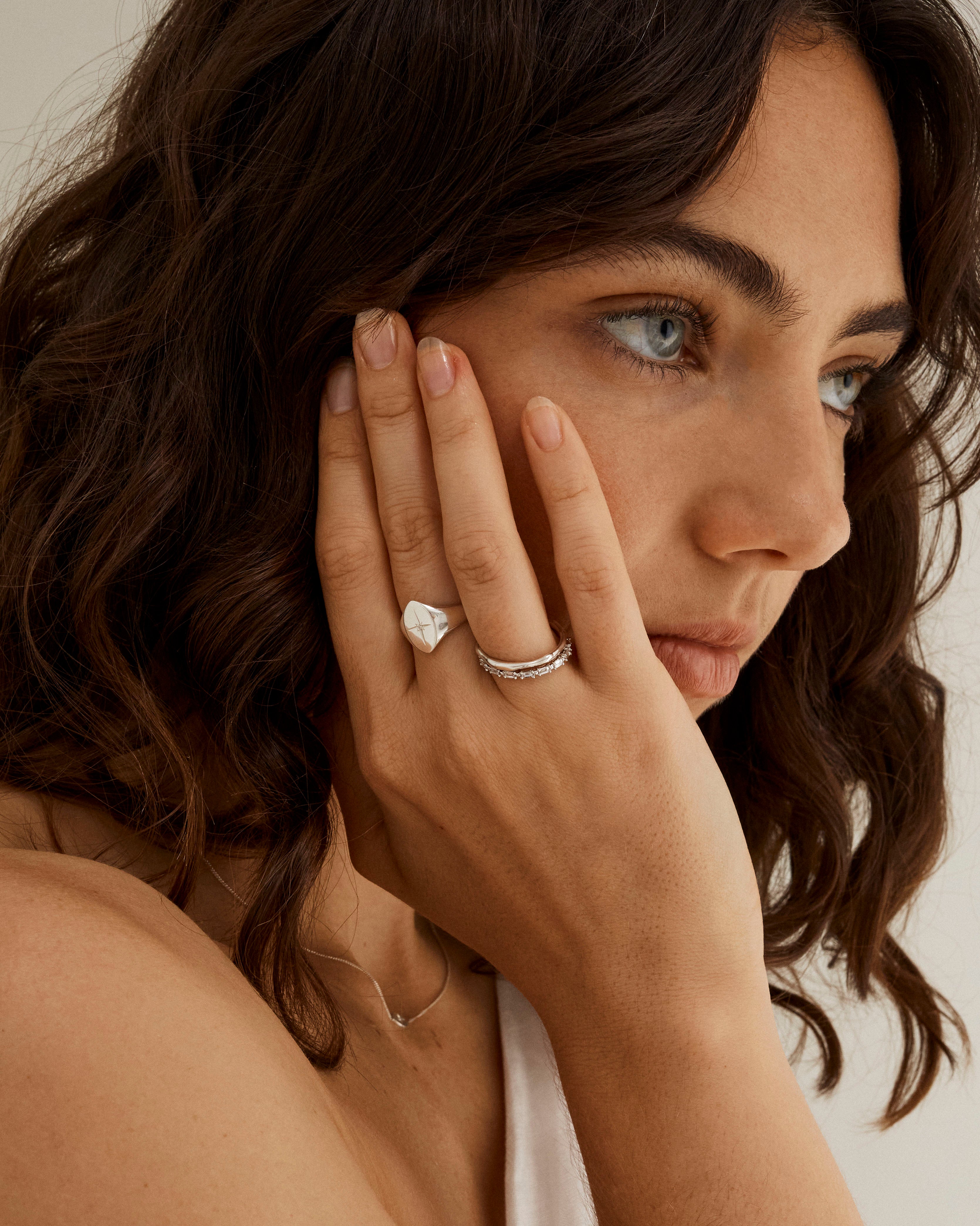 A woman wearing the Willow Signet Ring Millgrain | Birthstone with a Diamond in white gold. 