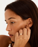 A model wears our vintage inspired emerald cut ring with diamond set shoulders either side