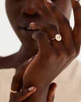 A model wears a round rutilated quartz halo ring
