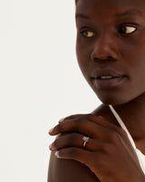 A model wears a pear cut solitaire featuring a tourmalinted quartz