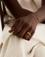 A model wears an oval wrap ring featuring smokey quartz