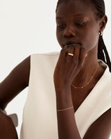 A model wears our fine Figaro chain in yellow gold