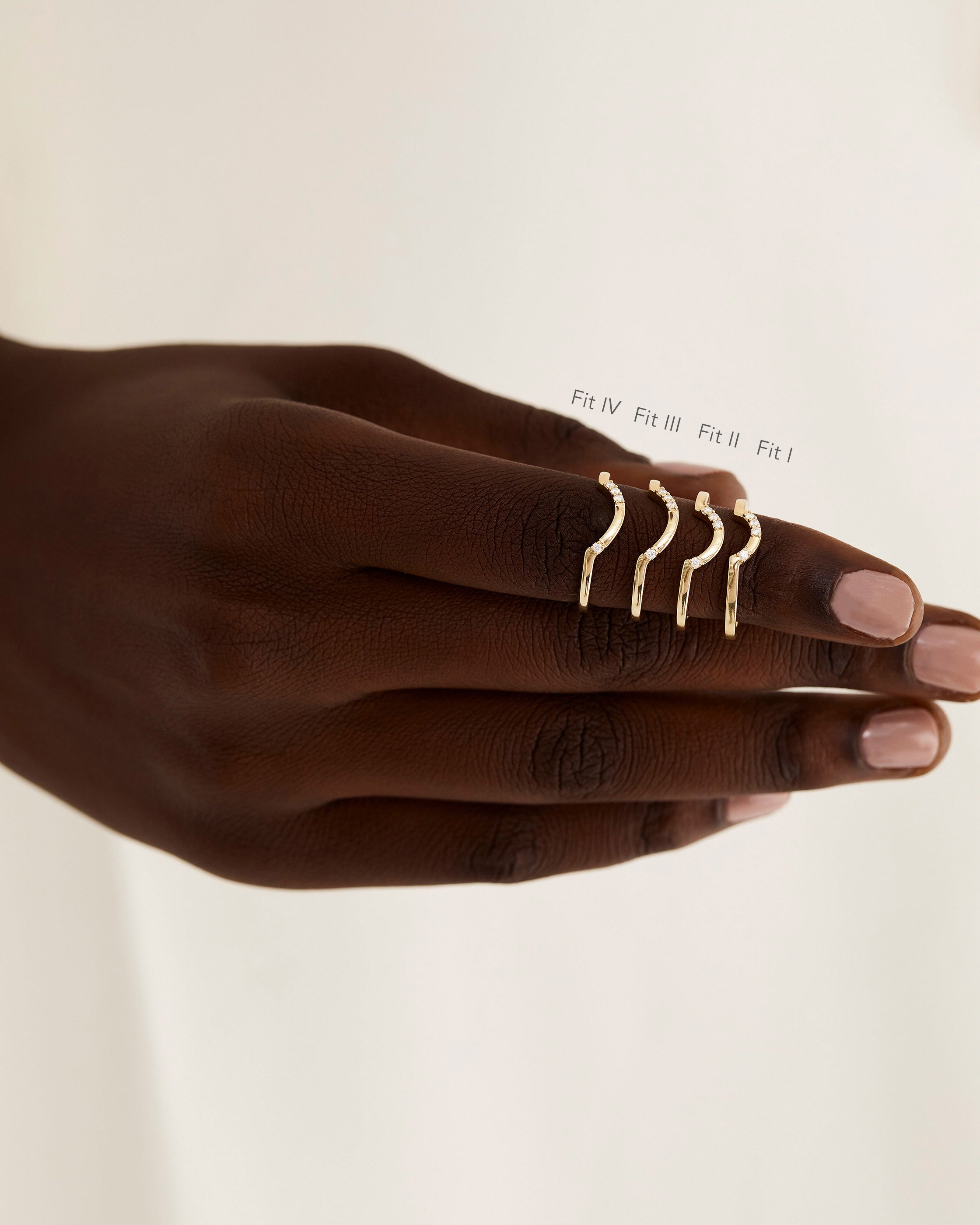 A model shows the four different sizes of a diamond detailed crown style ring