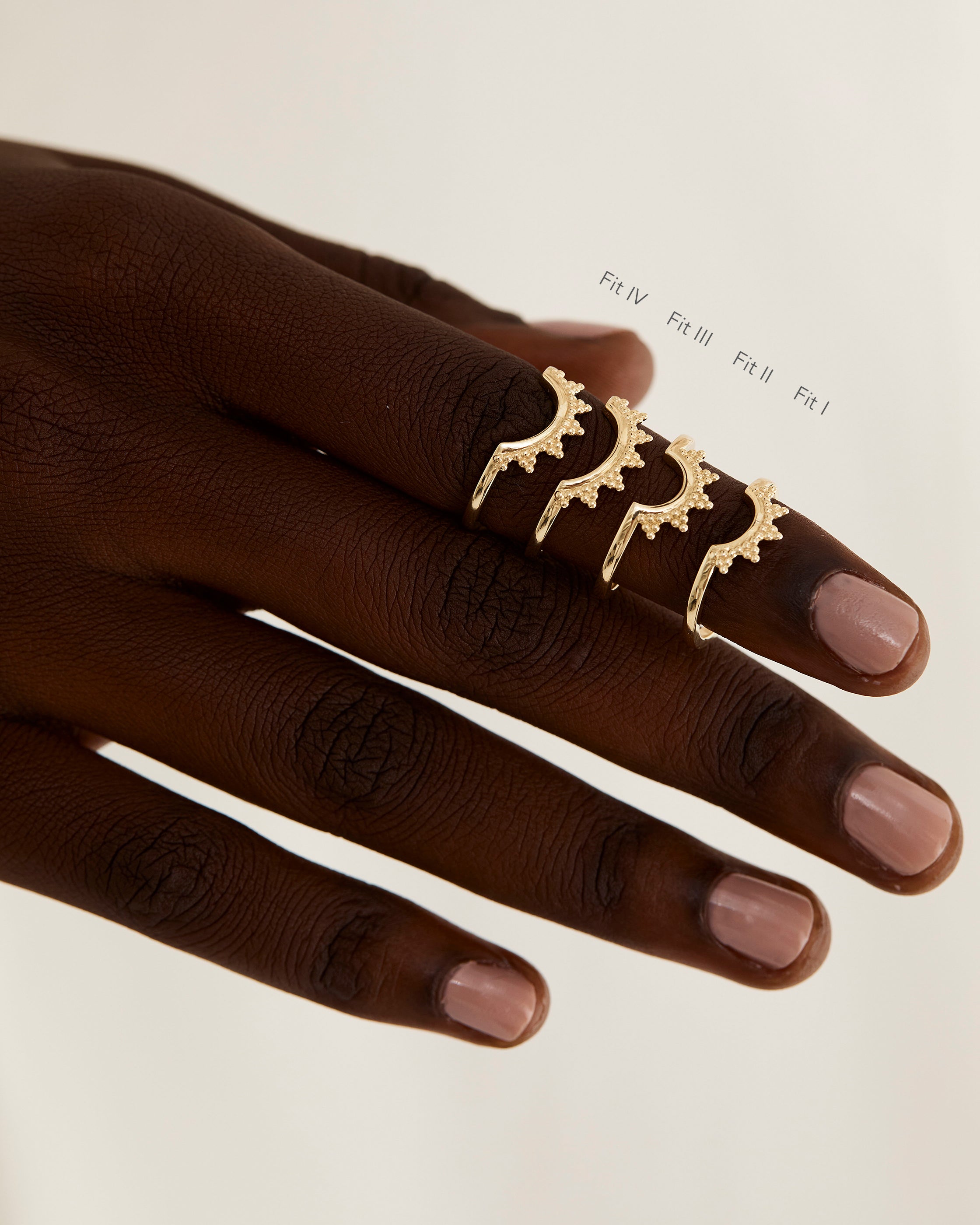 A model shows the four different sizes of a dot detailed crown style ring