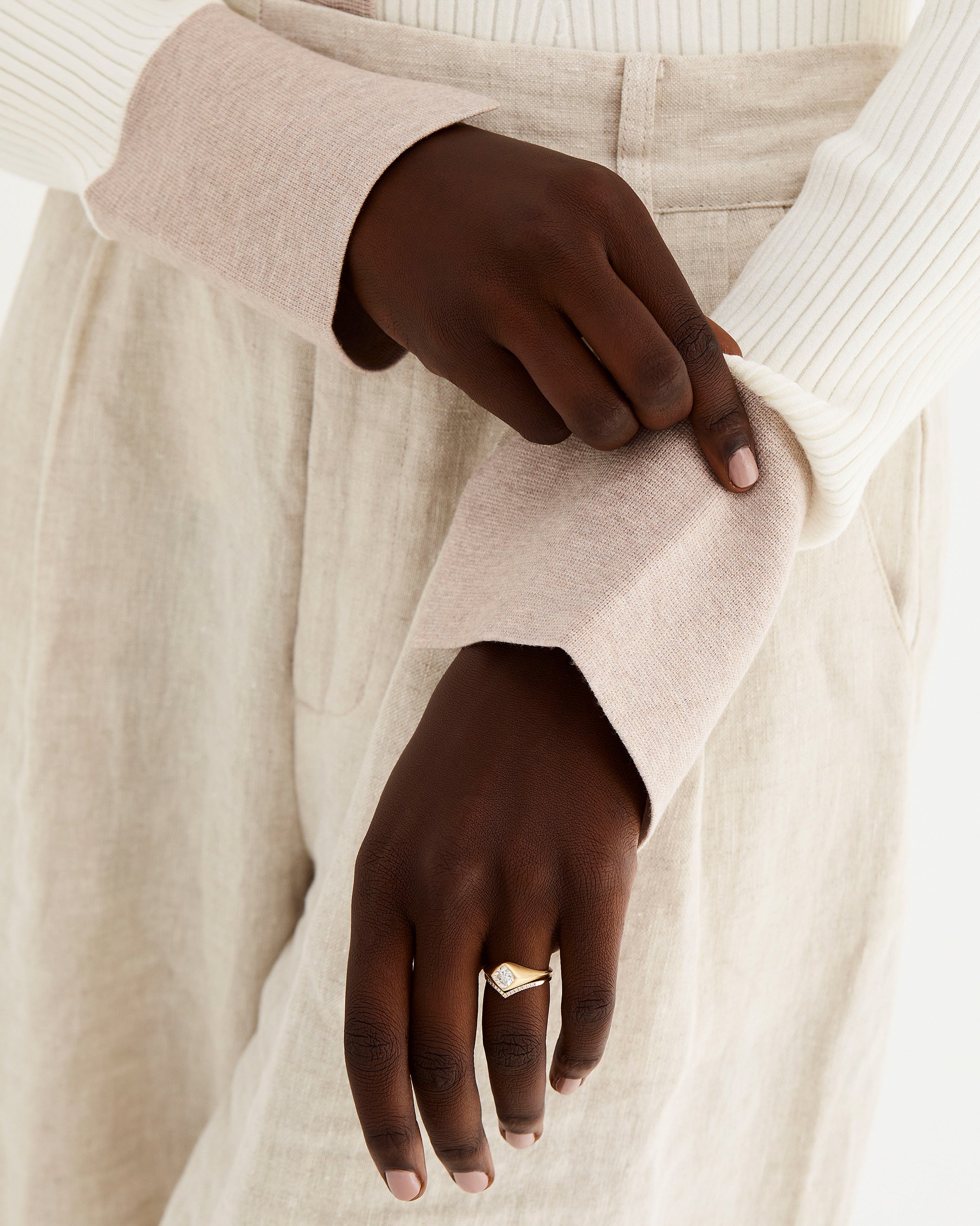 Model wears a signet inspired engagement ring with our gentle point diamond ring.