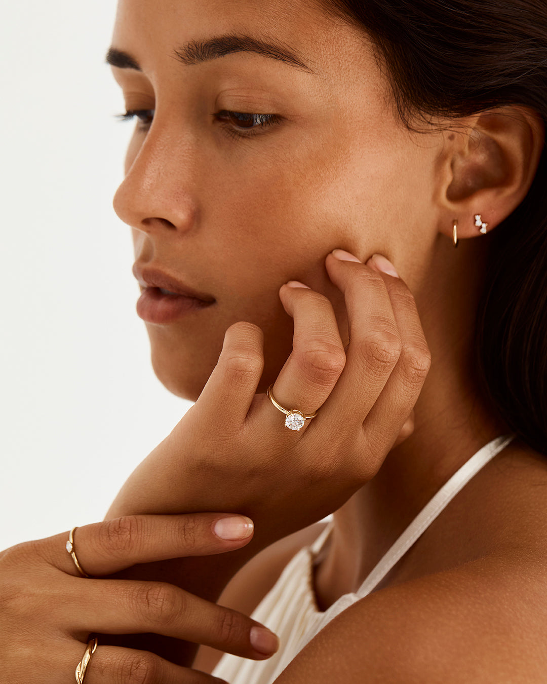 A model wears a round solitaire engagement ring with a laboratory grown diamond