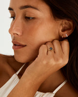 A model wearing a round solitaire style engagement ring featuring a Australian Sapphire.