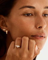 A model wears an pear trio engagement ring with a morganite