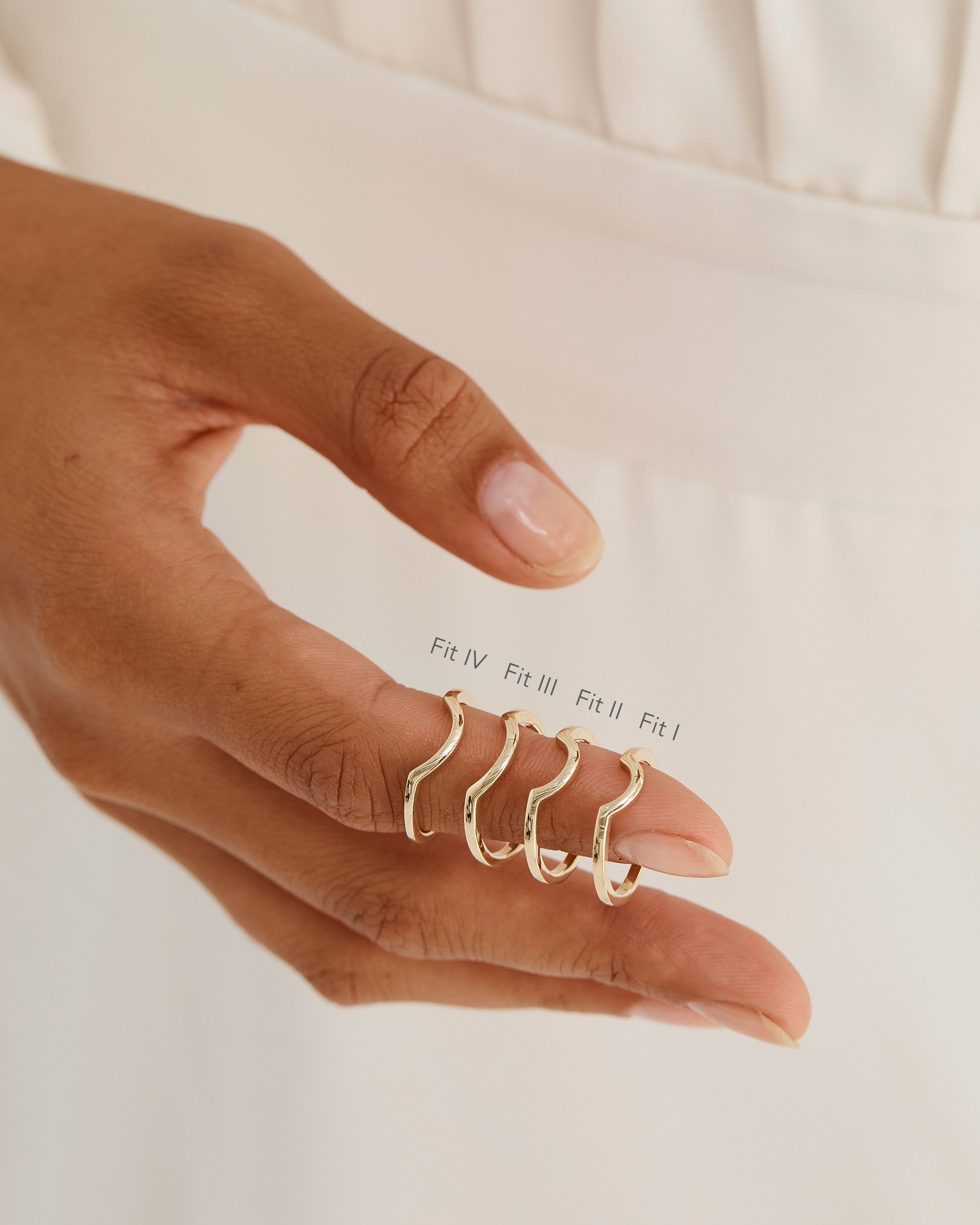 A model shows the four different sizes of a crown style ring