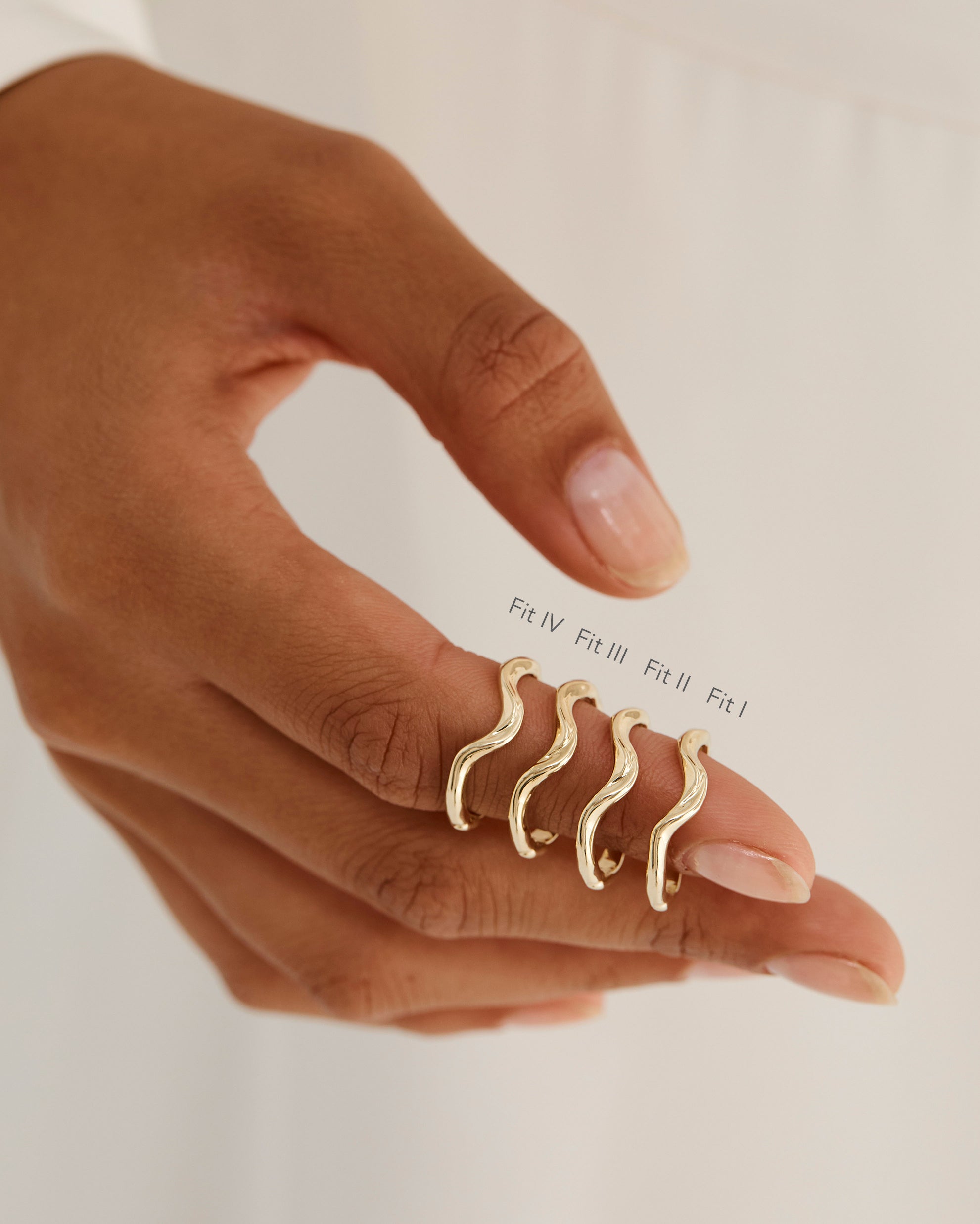 A model shows the four different sizes of an organic inspired crown style ring