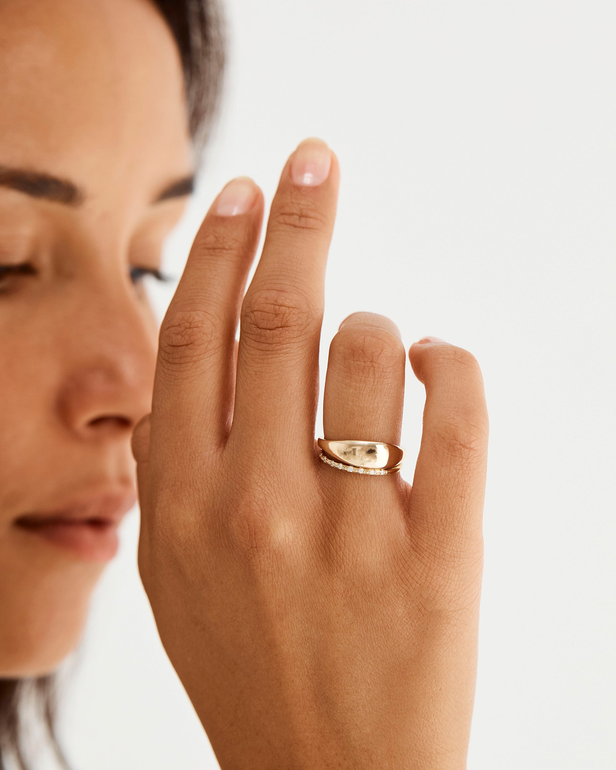 Model wearing our dome style signet ring, stacked with a fine diamond cascade band