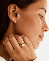 Model wearing our 2mm organic textured wedding band with a diamond signature solitaire