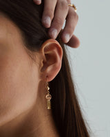 A close up on a woman wearing the Bea Vintage Earrings