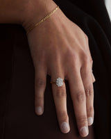 A hand adorned with the Clementine Vintage Ring | Diamonds and the Figaro Chain Bracelet